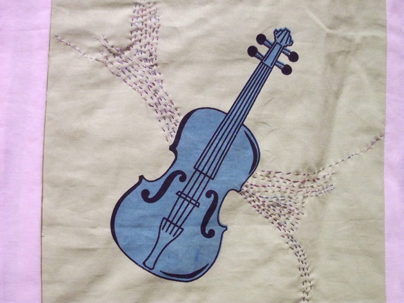 A piece of a blanket depicting a guitar