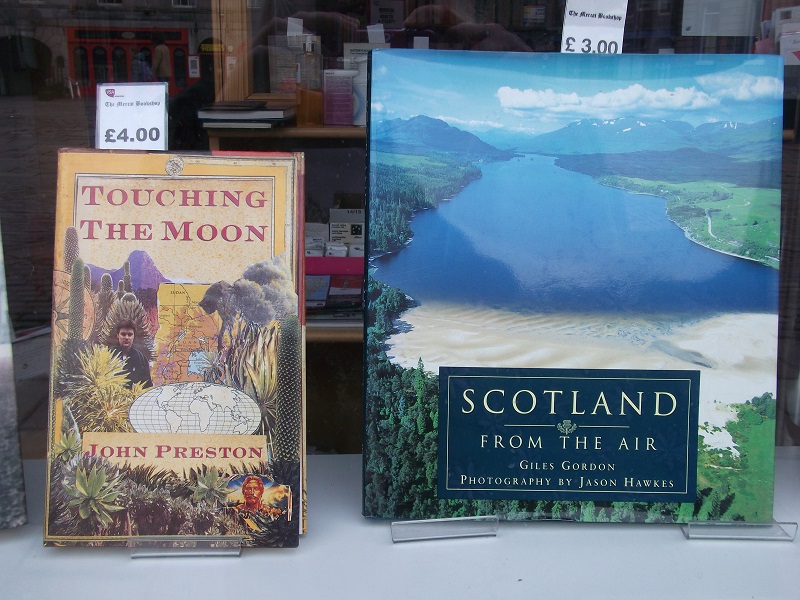 two books in window display. Touching the Moon and Scotland from the Air