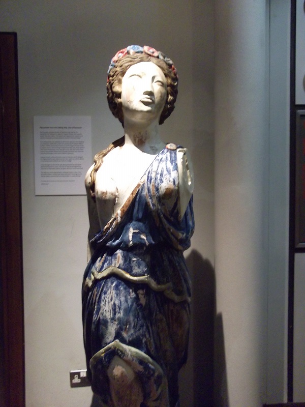 colourful figurine of a woman in a blue dress