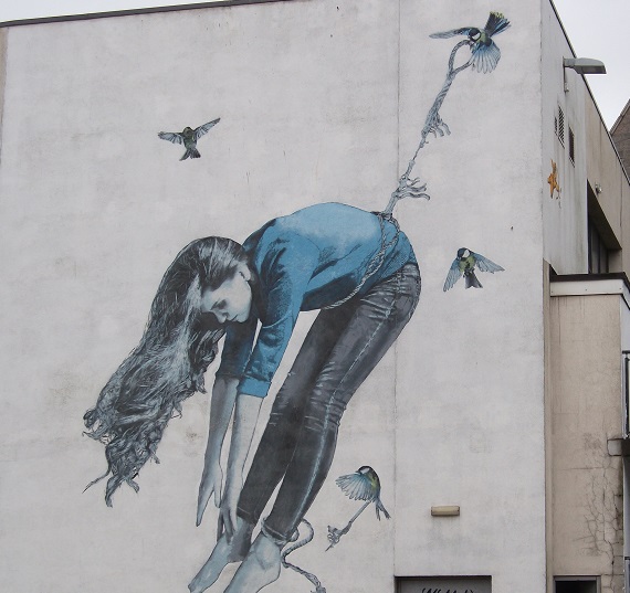 street art showing girl being pulled by birds