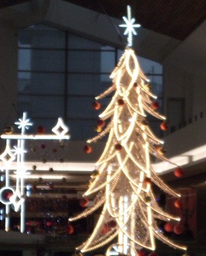 Christmas lights in the shape of a Christmas tree, hanging down from the ceiling of Union Square Shopping Centre
