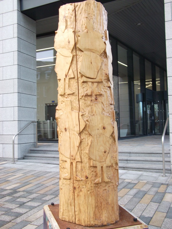 a wooden sculpture of twelve drummers drumming