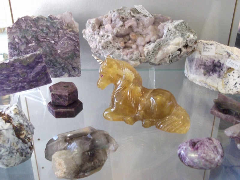 crystal rocks and a yellow carved unicorn crystal