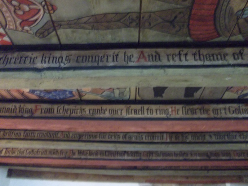 A painted ceiling with pictures and words