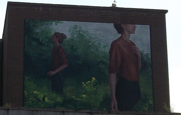 Street art showing two women against a backdrop of trees and green nature