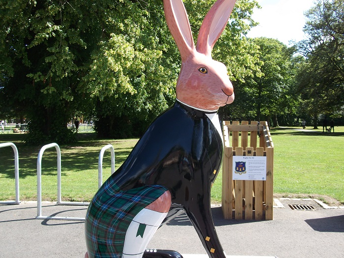 A hare sculpture by Sandra Russell featuring a hare in Scottish kilt and black jacket
