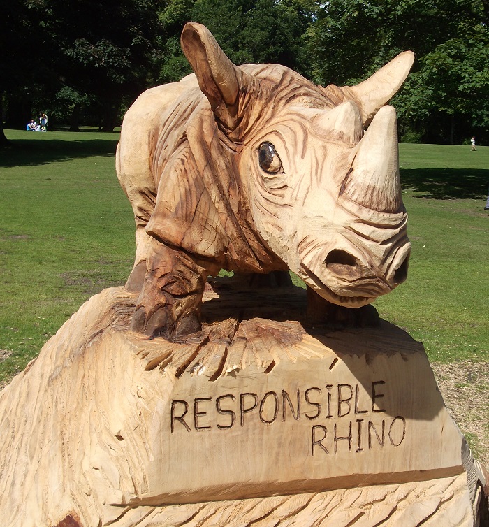 a wooden sculpture of a rhino