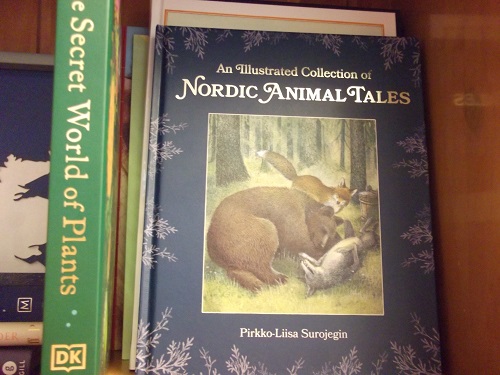 Books including Nordic Animal Tales with a picture of a bear and fox.