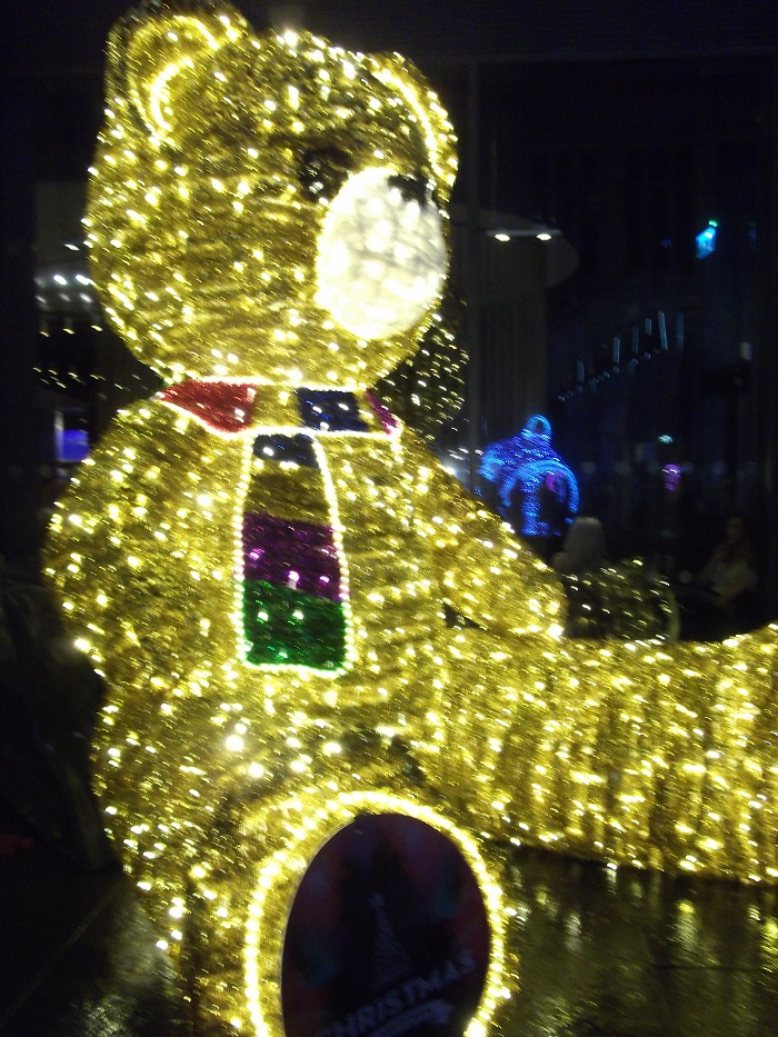 A giant teddy in gold light