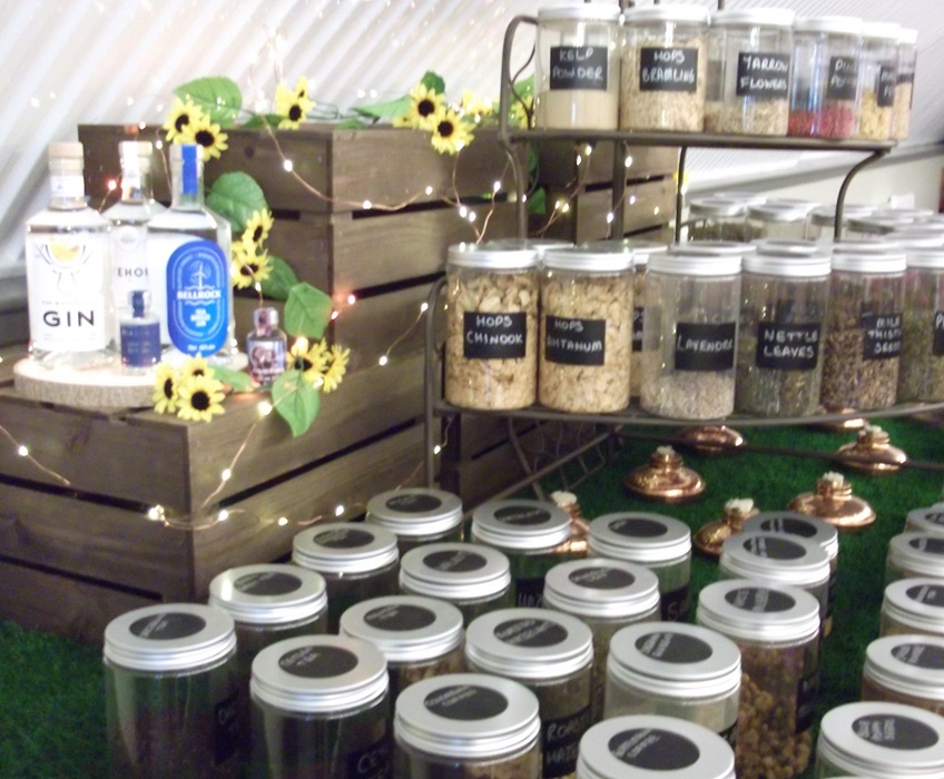 bottles of botanicals next to a sunflower display