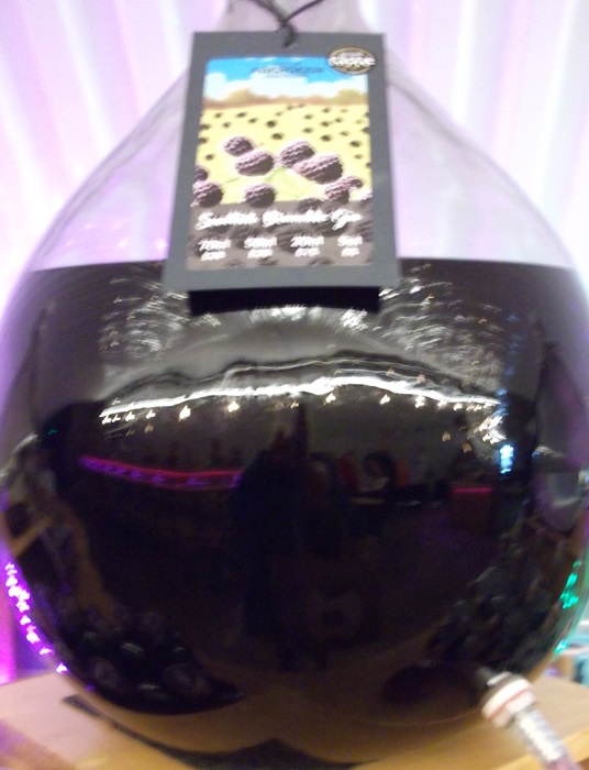 a rounded bottle with purple gin