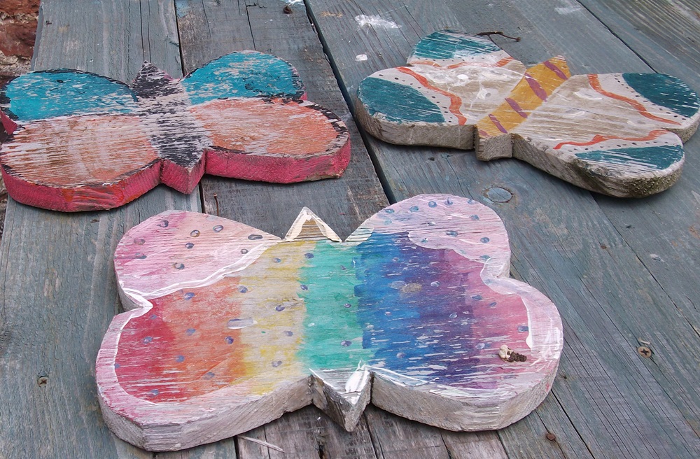 wooden butterflies painted pink, blue and purple