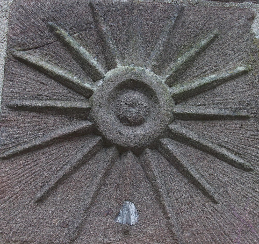 A stone engraving of the sun