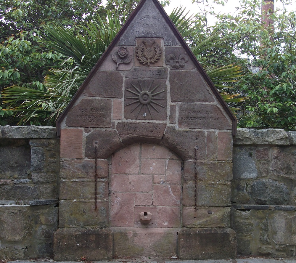 Stone structure with a gable top and engravings.