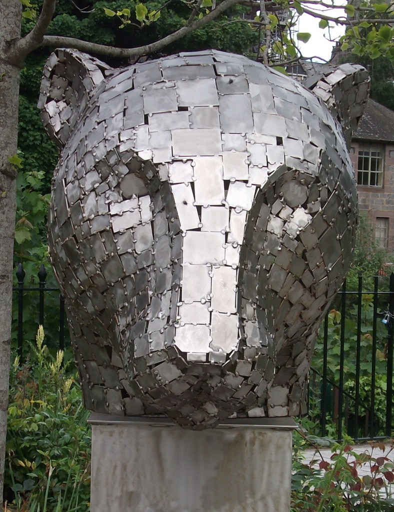 A silver sculpture of a leopard head