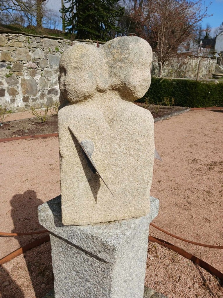 a stone sundial with faces