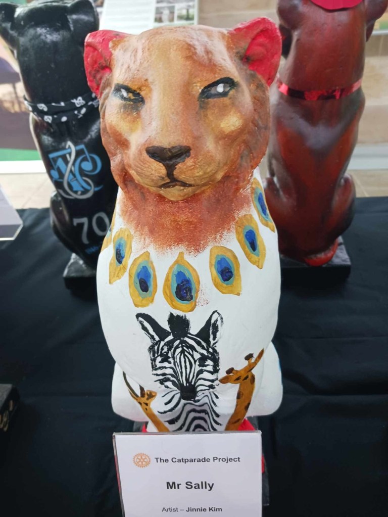 A brown car statue with images of a zebra and giraffe