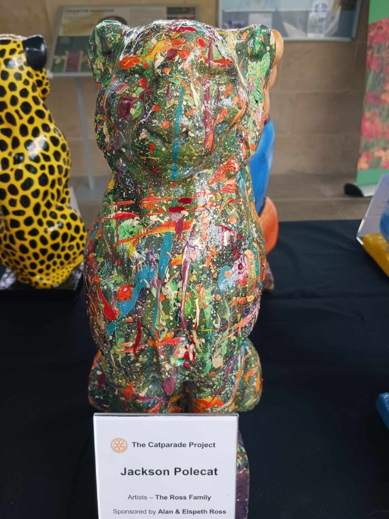 A cat statue painted many colours