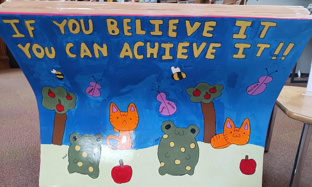 Cats and grey animals on a white background under trees and a blue sky with words You Believe It You Can Achieve It