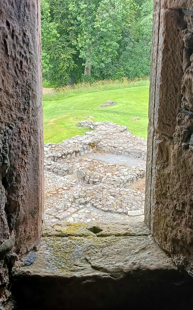 A stone window looking out to ground level stonework below