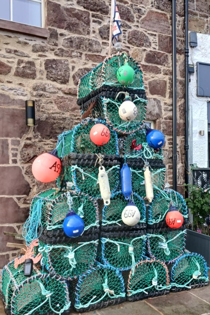 Fishing baskets piled on top of each other against a brick wall