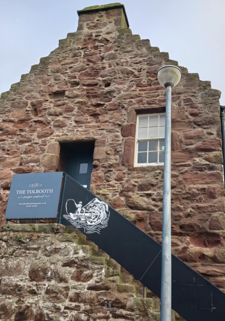 An old brick building with steepled roof