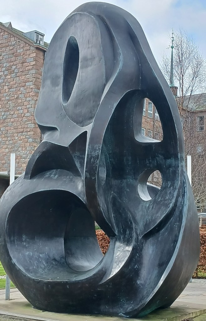 A large bronze sculpture depicting intertwining loops