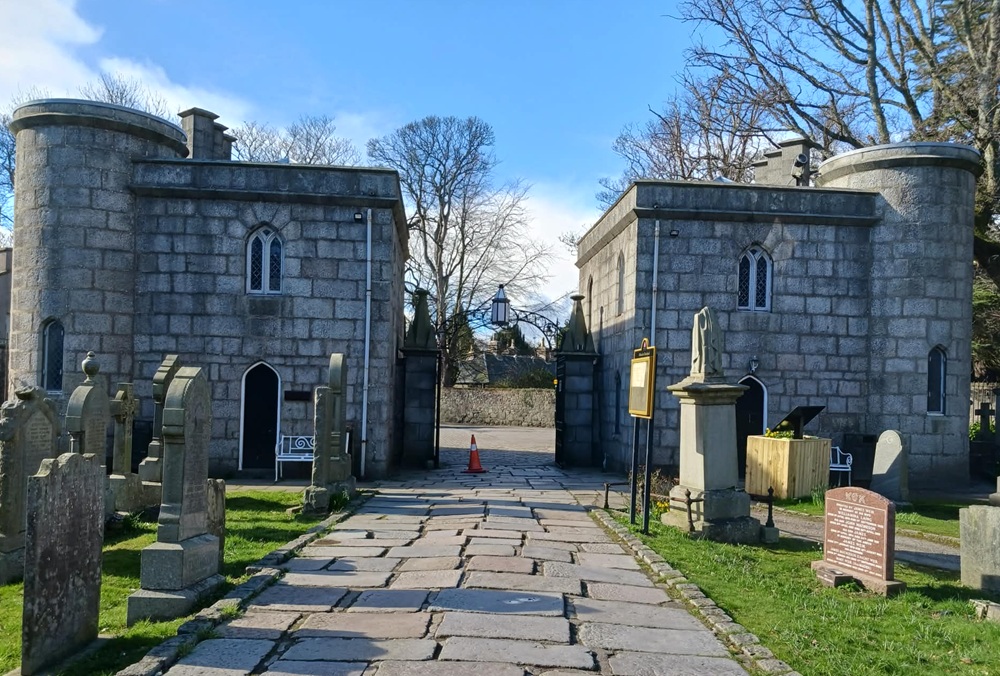 Two square buildings stand on each side of the cathedral entrance