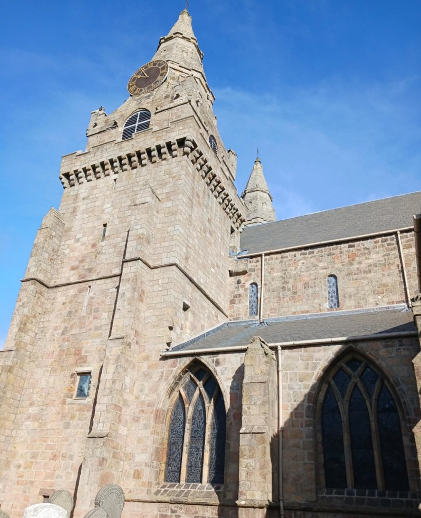 A cathedral building with spire and curved windows